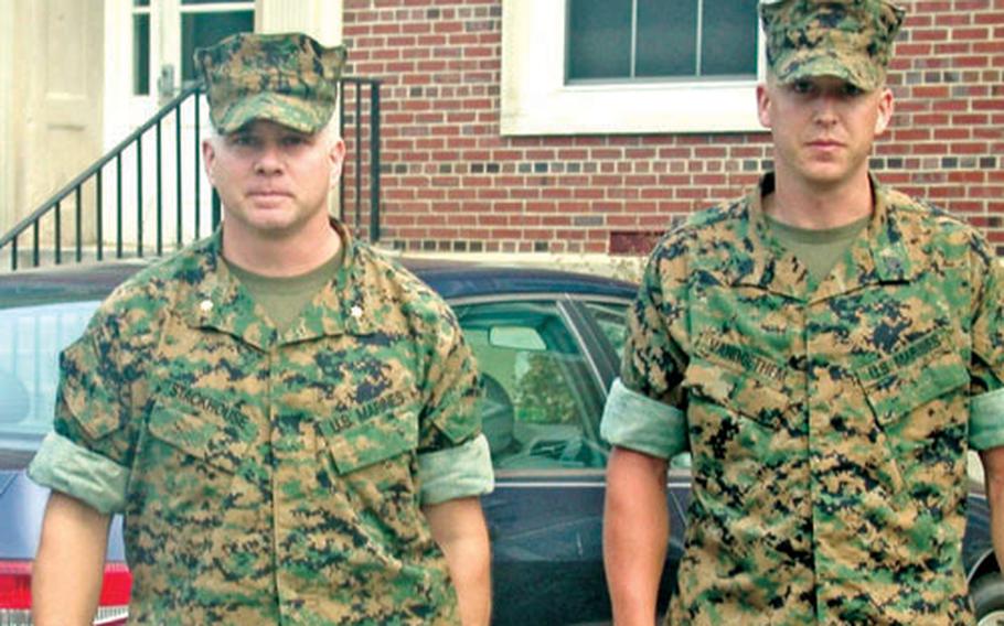 Marine Staff Sgt. Christopher R. VanGoethem, right, and his chief defender, Marine Maj. Phillip Stackhouse, leave court at Marine Corps Base Quantico, Va., after a day of testimony on July 25, 2005, in his Article 32 hearing. His court-martial began Tuesday at Quantico.