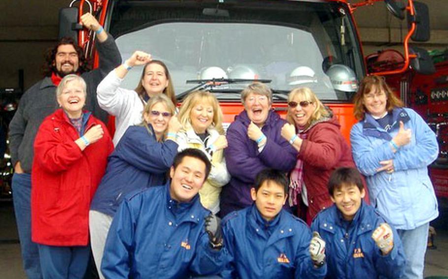 Members of the Phi Delta Kappa team that won $2,000 in the base scavenger hunt last weekend pose for a photo with Japanese firefighters at a Misawa city fire station. One of 261 items or tasks on the scavenger hunt list was to collect a team photo in front of a red fire truck; base fire trucks are yellow. Team members were Carol Powell, Lori Grant, Louise Warner, Ann Mitchell, David Wray, Patti Rzeznik, Deborah Markl and Connie Kaiser.