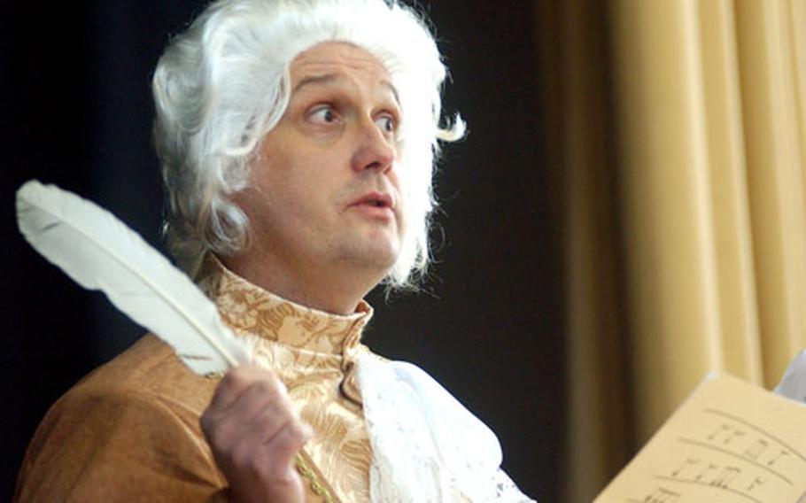 Wolfgang Amadeus Mozart, aka David Puckett, announces the next musical number at the Argonner Elementary School&#39;s Mozart Festival at the Hanau, Germany school on Thursday. Mozart would have been 250 on Friday.