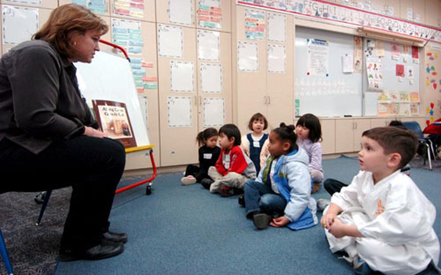 Children go over what they need to do to help them read and understand books with teacher Diane Garoutte at The Sullivan’s Elementary School at Yokosuka Naval Base, Japan, on Tuesday.