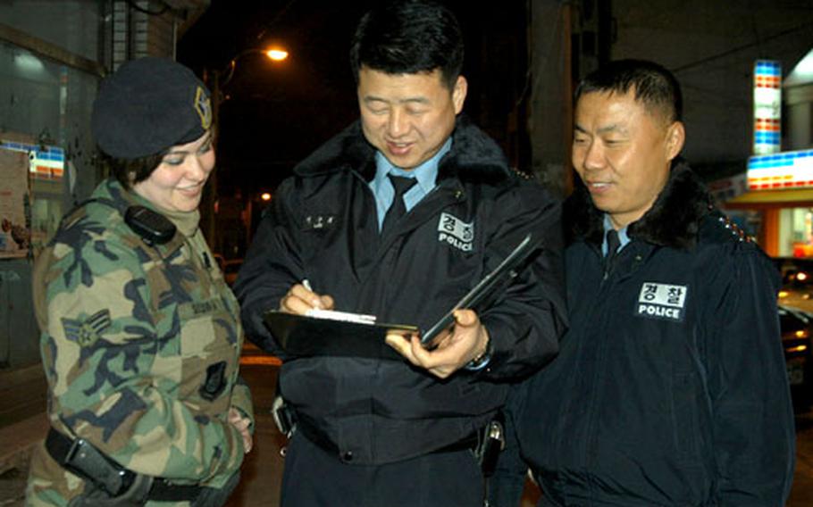 Senior Airman Shannon Sullivan of Kunsan Air Base’s town patrol teams up with Korean National Police officers as part of joint weekend patrols begun earlier this month. Sullivan is a member of the 8th Security Forces Squadron, part of the 8th Fighter Wing.
