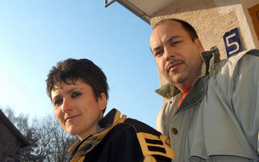 Beate and Michael Schleich stand on the front stairs to their house in Erlensee, Germany. The couple says U.S. Army helicopters from Fliegerhorst Casern would fly low enough in the space between their house and the one next door, that they could see pilots.
