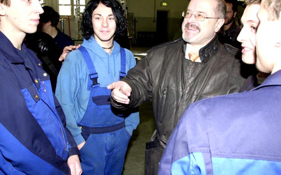 Bavarian State Secretary Jürgen Heike meets German apprentices at Grafenwöhr’s Base Support Operations motor pool on Monday.