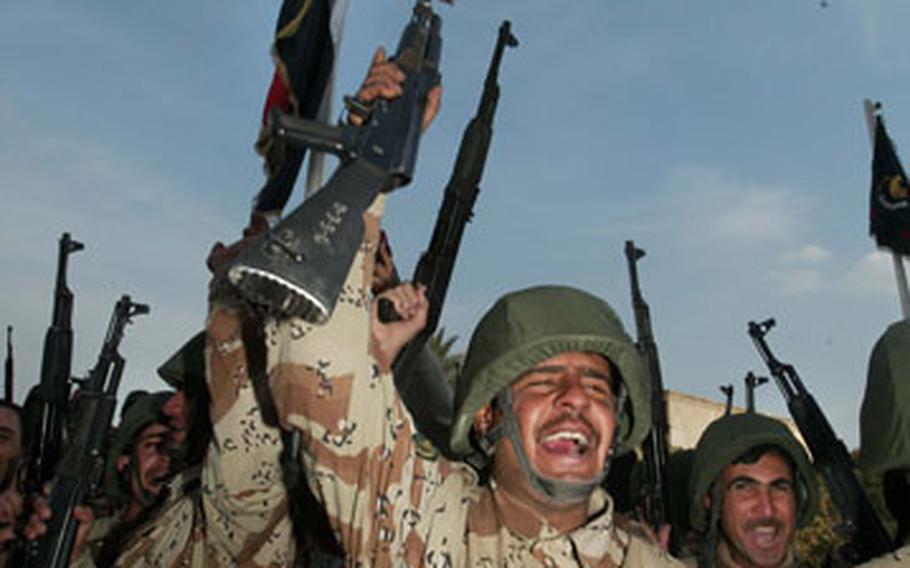 Iraqi soldiers of the 5th Brigade celebrate during a transition-of-authority ceremony of Forward Operating Base Camp Honor on Tuesday in Baghdad.