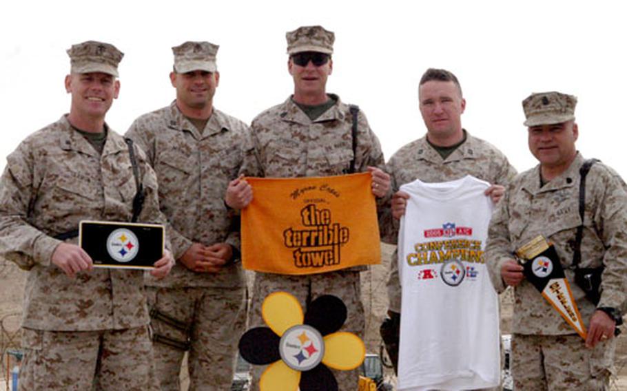 From left, Lt. Col. Timothy B. Seamon, Capt. Trent Morrow, Gunnery Sgt. Stephen B. Johnson, Chief Petty Officer Mark F. Bryan, and Capt. Charles T. Atwood pose with Steelers memorabilia at Camp Taqqadum. All are assigned to the 2nd Marine Logistics Group (Forward).