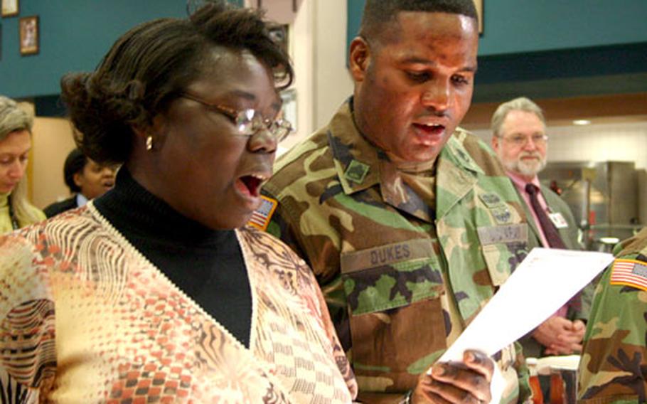 Army Staff Sgts. Jennifer Simmons and John Dukes sing “Lift Every Voice and Sing” during a luncheon Wednesday at Naval Support Activity Naples, Italy, that celebrated Black History Month and honored the Rev. Martin Luther King Jr.