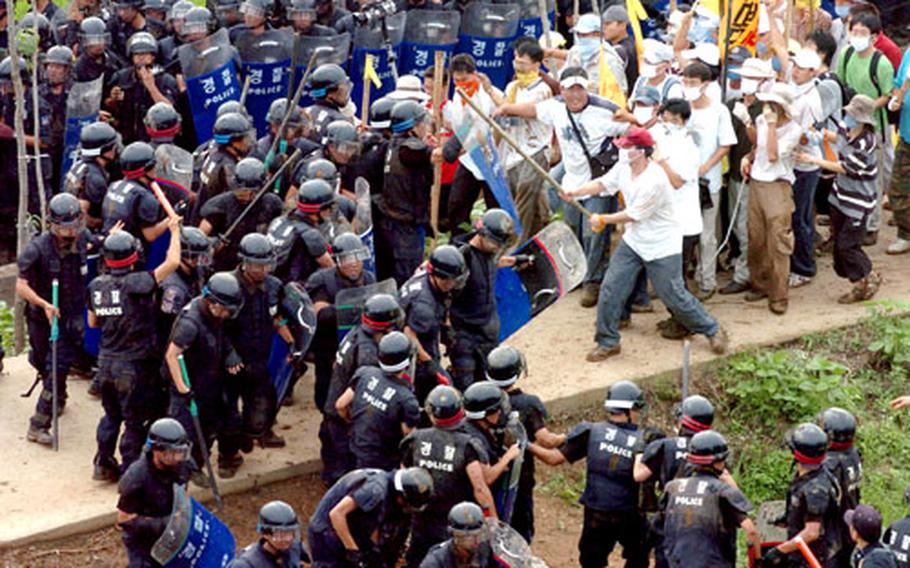 South Korean riot police battle demonstrators outside Camp Humphreys in Pyongtaek, South Korea, in July 2005. Korean National Police say 893 South Korean riot police were injured during protests last year.