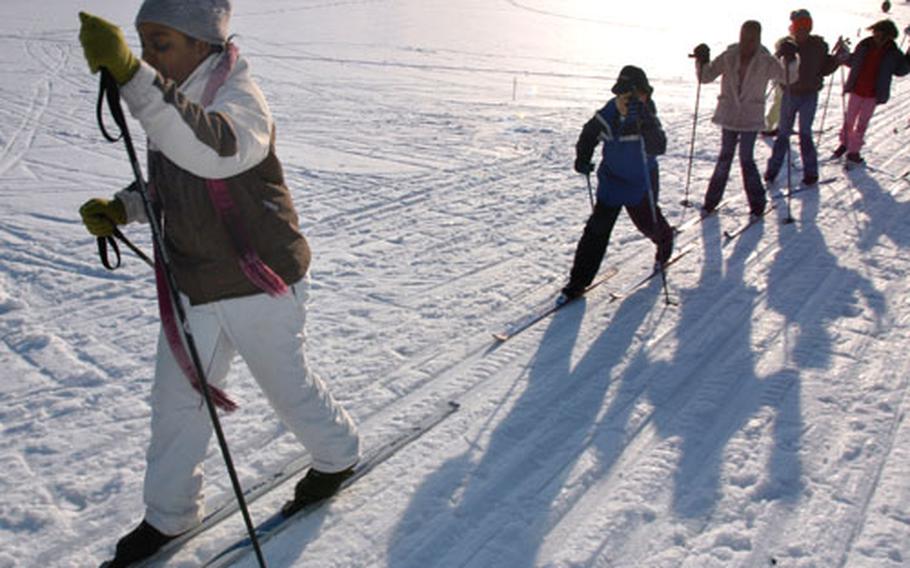 Tunisia Jenkins, a fifth-grader at Cummings Elementary School on Misawa Air Base, Japan, leads a group of Nordic skiers Tuesday on Gosser Memorial Golf Course. Every day after school, a small group of students skis on the course. Two fresh sets of ski tracks are groomed daily around the course perimeter.