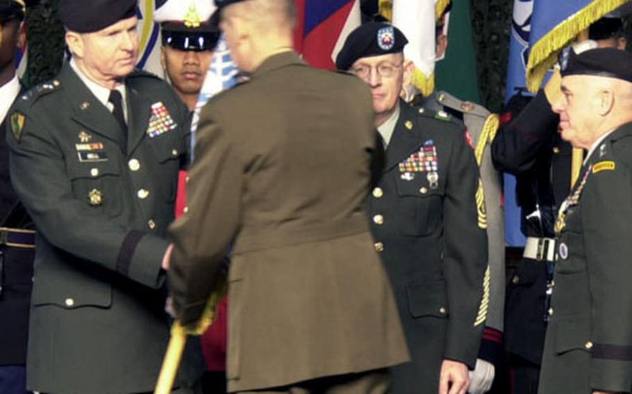 Army Gen. B.B. Bell, left, accepts the United Nations Command colors from the chairman of the Joint Chiefs of Staff, Marine Gen. Peter Pace, during a change of command ceremony Friday at Yongsan Garrison, South Korea. Bell assumed command of the United Nations Command, U.S. Forces Korea and the Combined Forces Command from Army Gen. Leon LaPorte, on the right. Facing the camera is Command Sgt. Maj. Barry Wheeler.