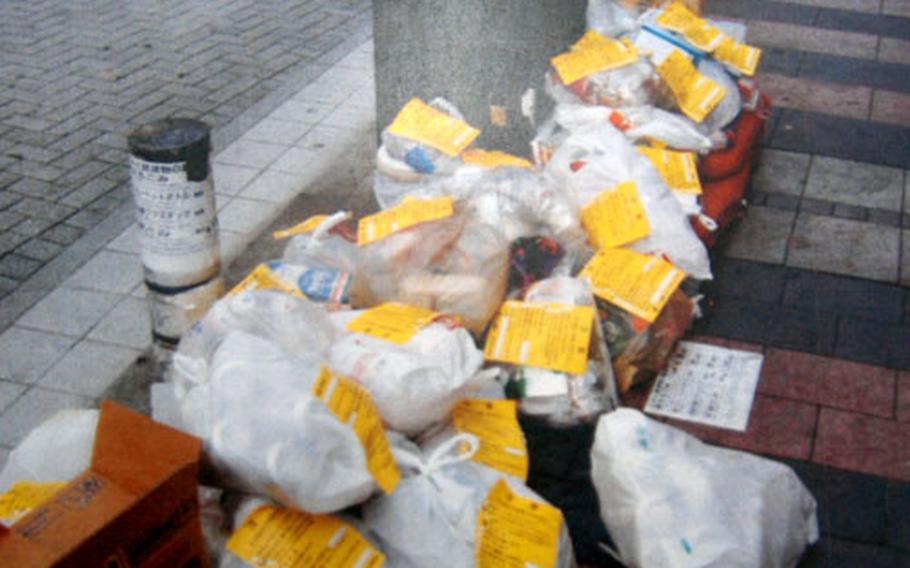 The yellow notices are warnings on unsorted trash left by residents of the City of Yokosuka. The city and Yokosuka Naval base officials made a recent push to educate Naval personnel living off-base on the proper way to dispose of trash.