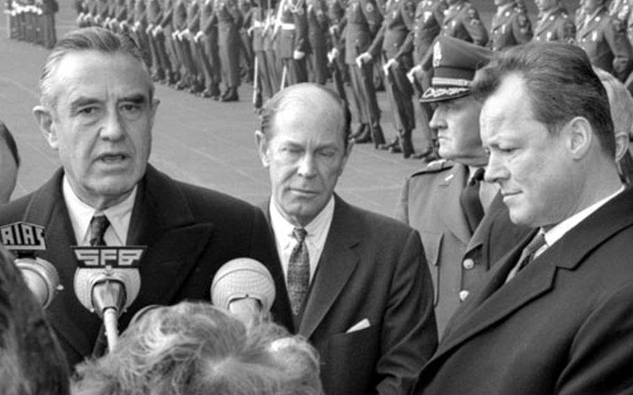 W. Averell Harriman, U.S. Ambassador to West Germany Walter C. Dowling, center, and West Berlin Mayor Willy Brandt meet the press.
