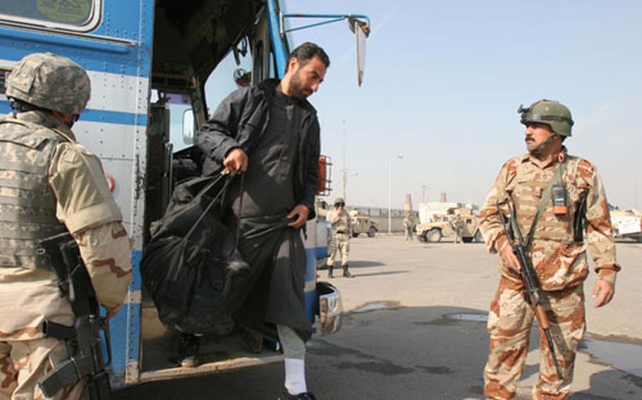 An Iraqi detainee walks from a bus at a central bus station after being released from a Baghdad jail on Sunday.