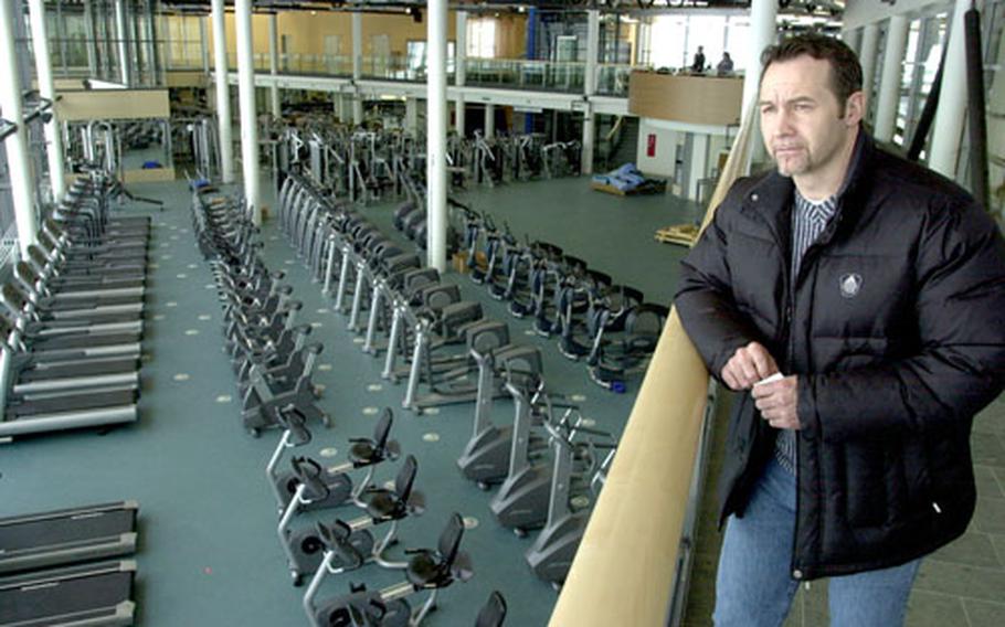 Serge Kearse, Grafenwöhr, Germany’s chief of sports and fitness, supervised the installation of equipment at the new Grafenwöhr fitness center Friday.