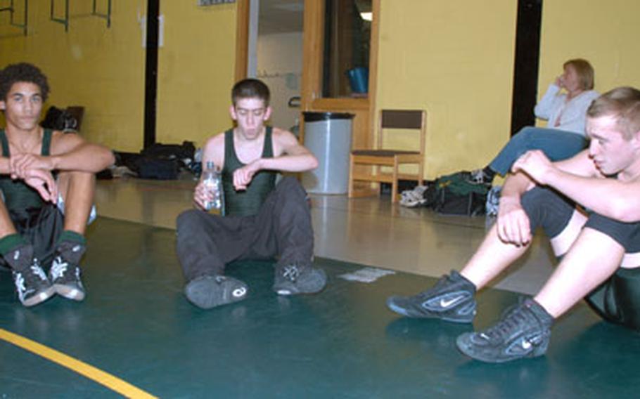 Alconbury High School wrestlers Kyle Lucas, left, Joshua Williamson and Douglas Bagnall take a breather at a recent practice.
