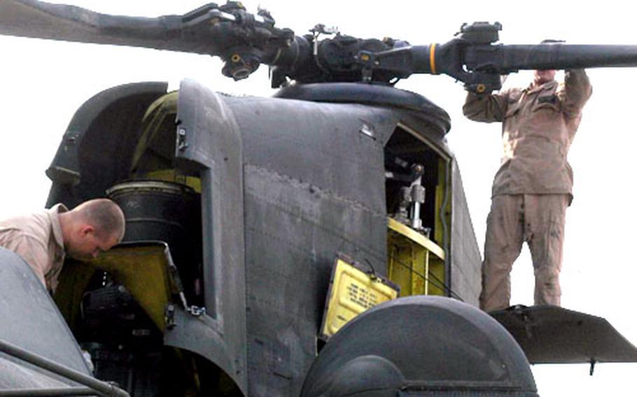 Specialists Shane Hubbard, left, and Corey Mullins, inspect a Chinook helicopter that had just completed a mission and returned to Bagram Air Base in Afghanistan. Big Windy and other Army aviation units based in Germany will soon be returning home from a yearlong stint supporting Operation Enduring Freedom.