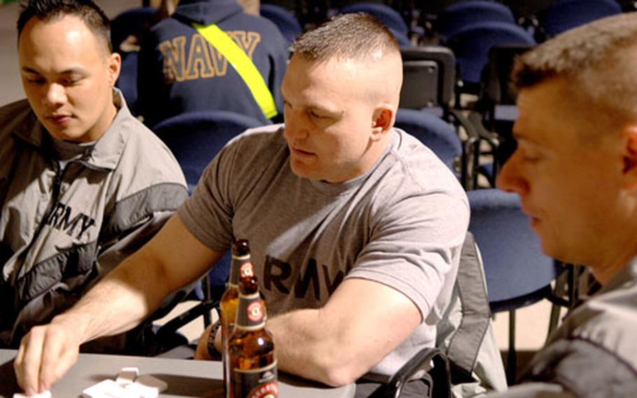 First Lt. Travis Gilbert, 34, center, enjoys his first beer since returning from a yearlong deployment in Afghanistan.