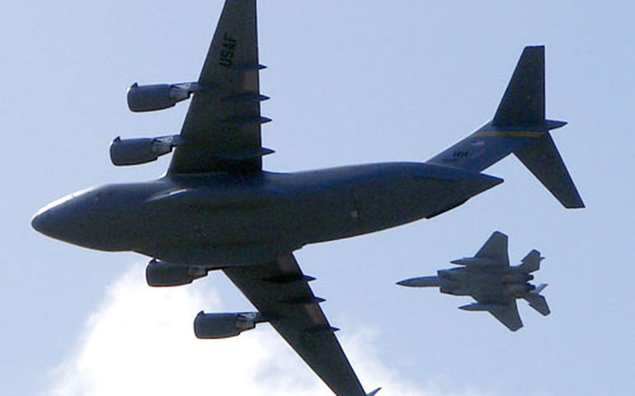 The Spirit of Hawai'i-Ke Aloha and an F-15 from the Hawaii Air National Guard perform a fly-by on Wednesday.