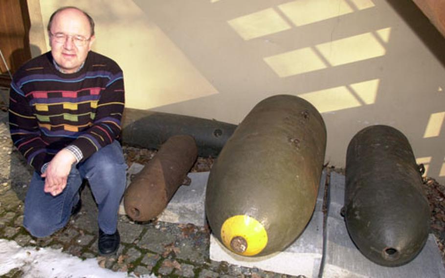 Grafenwöhr Military Museum curator Olaf Meiler with some of the bombs dropped on the town and post on April 5 and 8, 1945.