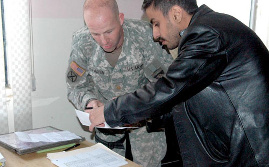 Maj. Eric McFadden consults with Osama Nabil, an Iraqi engineer who was kidnapped in November while he was working on American-led reconstruction projects south of Baghdad.