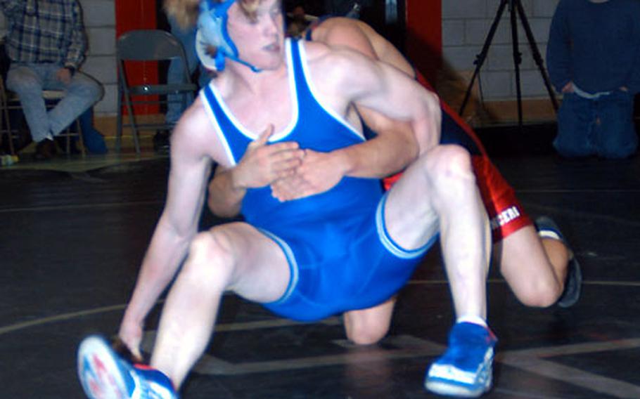 Alex Cook of London Central, blue, grapples with Lakenheath’s David McBride.