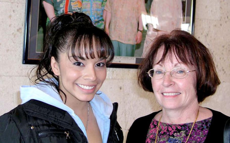 Amanda Garcia, a Kadena High School student, takes a break with her marine biology teacher, Jayne Schilke, at a symposium Sunday at the Bankoku Shinryokan conference hall in Nago.