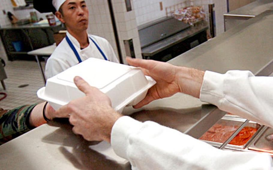 An airman picks up lunch recently in the Samurai Cafe at Yokota Air Base, Japan. The dining facility was named best in Pacific Air Forces last fall and is now in the running for the 2006 Hennessy Award, the service’s top honor.