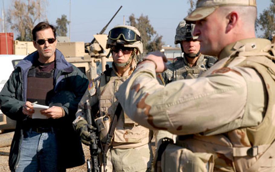 ABC News anchor Bob Woodruff, left, listens as Maj. Bill Taylor, an advisor to the Iraqi army, gives a patrol brief minutes before departing on the mission, on Jan. 29. About two hours later, Woodruff and cameraman Doug Vogt were injured by a roadside bomb near Taji.