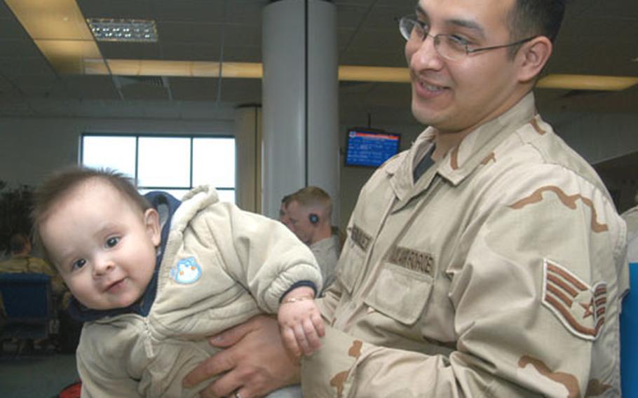Staff Sgt. Joel Fernandez plays with his 8-month-old son, Jeremy, as he waits for a flight out of the RAF Mildenhall passenger terminal on Thursday. Fernandez, an aircraft communication and navigation maintainer from Mildenhall's 352nd Maintenance Squadron, left to a four-month deployment to Iraq.