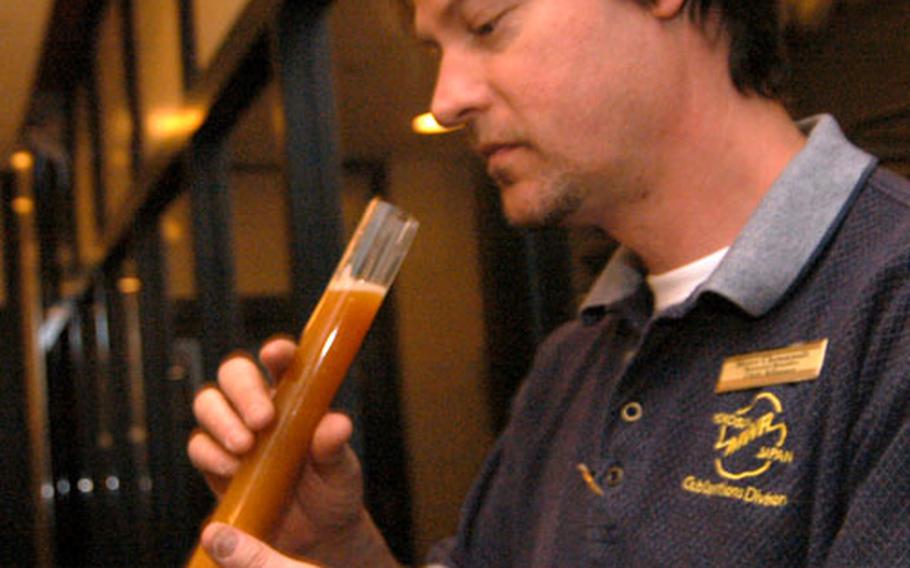 Brewers Assistant Steve Chennault tests some of the American Amber concocted at Sharky’s Beverage Company at Yokosuka Naval Base, Japan.