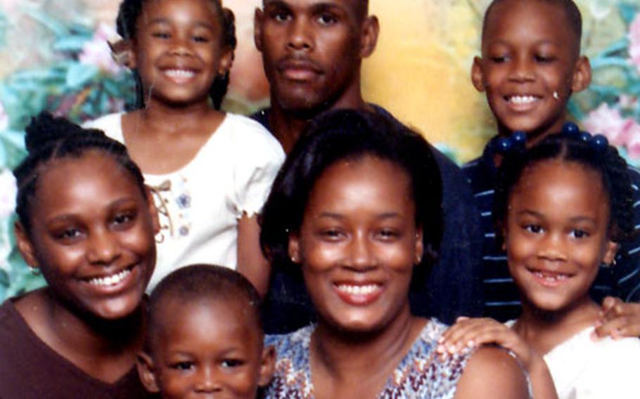 The Parker family: Pvt. James Parker is flanked in the back row by his children ReShaya, 9, and Darrian, 11. In the center row, from left, are Jamesha, 14, DeRessia Parker, and Jaressia, 8. James, 5, is on DeRessia’s lap. Not shown is Janae, 3 months.