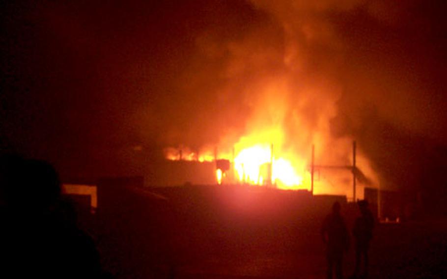 The main building at FOB Yusafiyah burns on Feb. 5.