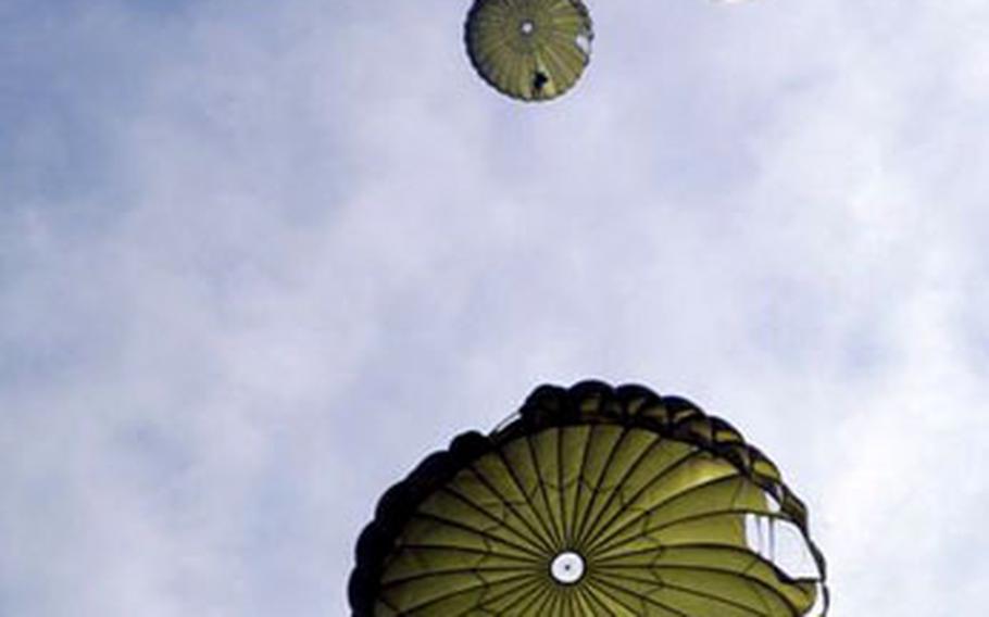 Special Operations Command-Korea members glide toward the ground during a balloon-powered airborne exercise Feb. 13. The soldiers performed the exercise in cooperation with the 2nd Battalion, 1st Special Forces group from Fort Lewis, Wash., and elements of South Korean Army Special Forces.