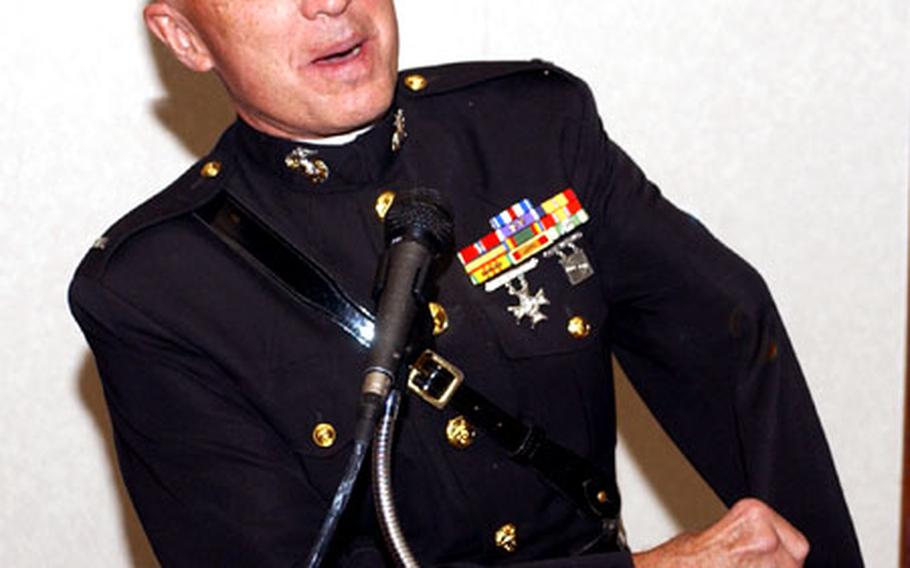 Former Marine Corps Lt. Clebe McClary speaks to the audience at the 48th Fighter Wing Commander’s National Prayer Luncheon. McClary, a Vietnam veteran and motivational speaker, recounted an attack in 1968 in which he lost his left eye and left arm.