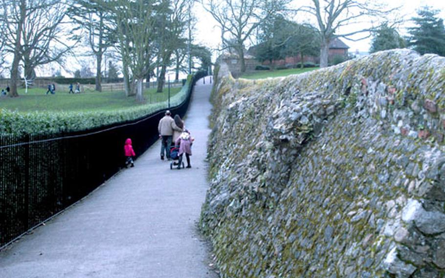 A family walks alongside a wall built by the Romans nearly 2,000 years ago.