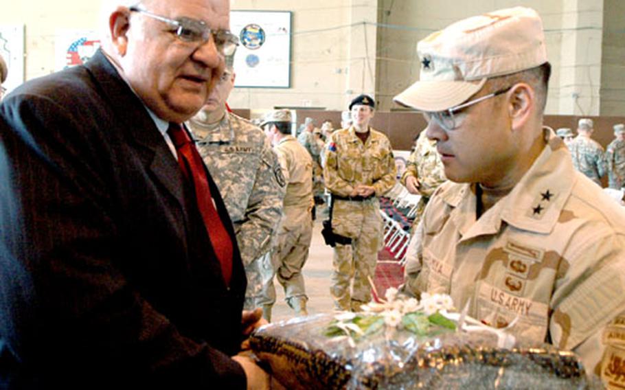Afghan Minister of Defense Rahim Wardak presents Maj. Gen. Jason Kamiyah with a gift to commemmorate his departure from Afghanistan.