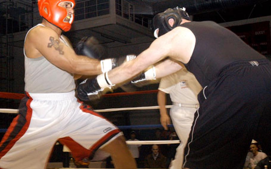 Staff Sgt. Geremy Ganaway, left, parrys a blow from Staff Sgt. Arthur Schuenke during a superheavyweight bout at the Army’s 2006 Crown Jewel boxing Invitational at Camp Carrol in Waegwan, South Korea. Ganaway defeated Schuenke in the bout; both are from Camp Carroll.