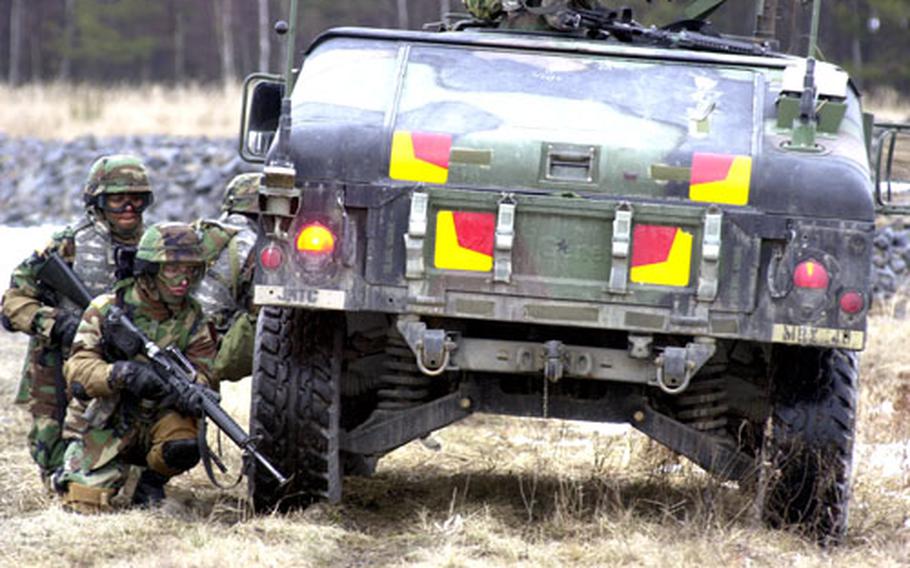 Soldiers with the 299th Forward Support Battalion react to an improvised explosive device and small arms fire during training at Grafenwöhr, Germany, on Wednesday. They battalion is expected to go on a mission to Iraq later this year.