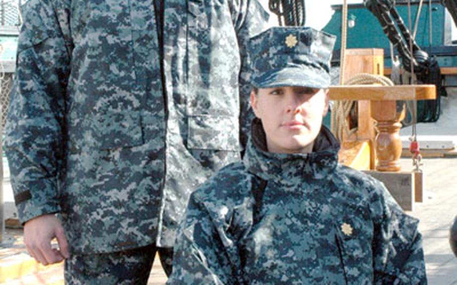Two Sailors pose aboard USS Constitution while wearing the blue digital patterned battle dress uniform concept. Chief of Naval Operations Adm. Mike Mullen approved plans for a single working uniform for all ranks, E-1 to O-10.