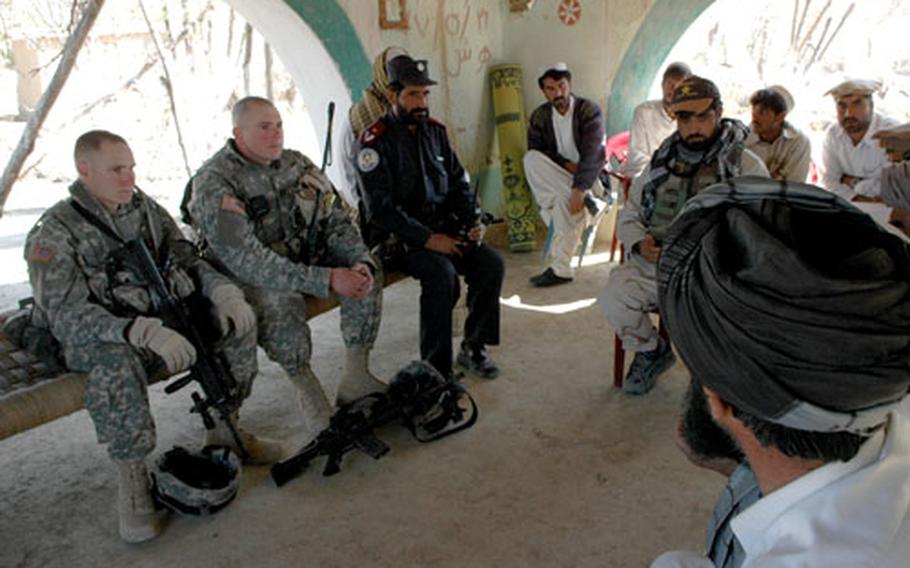 Capt. Bradford Garrison, second from left, meets with locals in Khowst province.