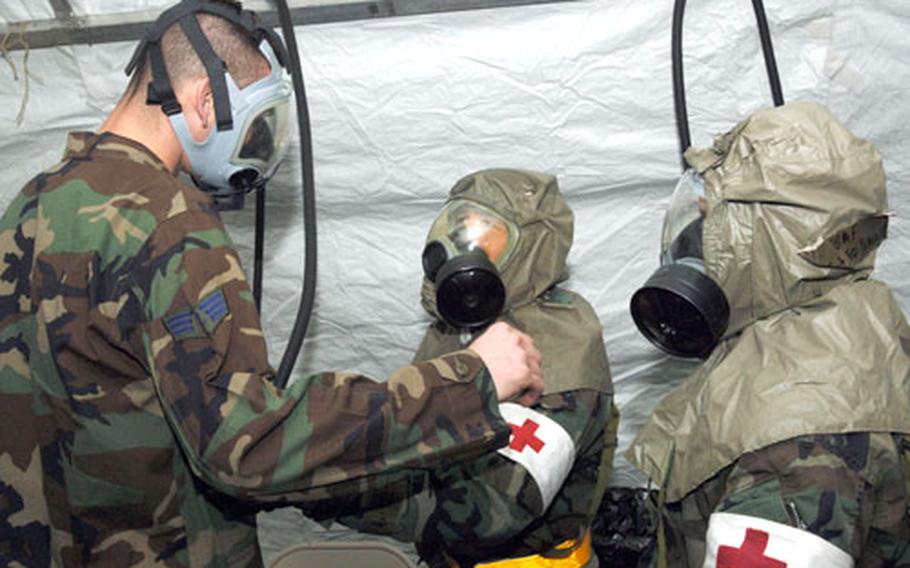"Contaminated" patients pass through a decontamination tent connected to the 374th Medical Group's emergency room entrance before admission to the hospital during an Operational Readiness Exercise at Yokota Air Base, Japan, in January. Since hospital staff members, including physicians and technicians, have specific roles during exercises, Yokota's primary care clinics commonly defer routine appointments until the end of a basewide drill or inspection. But medical officials say essential services are never shut down.
