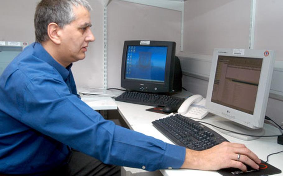 Phil Hammond, an information technology administrator for the 48th Contracting Squadron, checks the database backups. Last month, Hammond received the 2005 USAFE Outstanding Contracting Support award.
