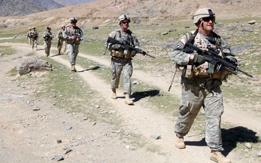Soldiers of 3rd Platoon, Company B, 2nd Battalion, 503rd Infantry Regiment, 173rd Airborne Brigade and 1st Platoon, Company A, 2nd Brigade, 4th Infantry Regiment, 4th Brigade, 10th Mountain Division patrol near Forward Operating Base Arghandab in Afghanistan.