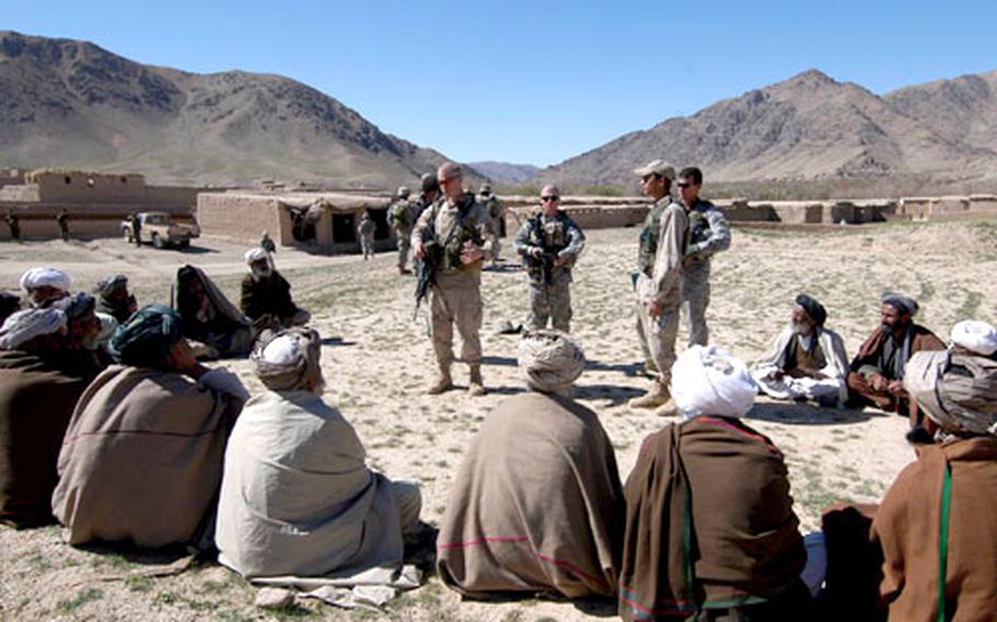Second Lt. Ian Dietz, left, of 3rd Platoon, Company B, 2nd Battalion, 503rd Infantry Regiment, 173rd Airborne Brigade, and 1st Lt. Ryan Edwards, 1st Platoon, Company A, 2nd Brigade, 4th Infantry Regiment, 4th Brigade, 10th Mountain Division, center, talk to village elders during an orientation tour of the villages near Forward Operating Base Arghandab in Afghanistan. The 10th Mountain soldiers are taking over the FOB from the soldiers of the 173rd.