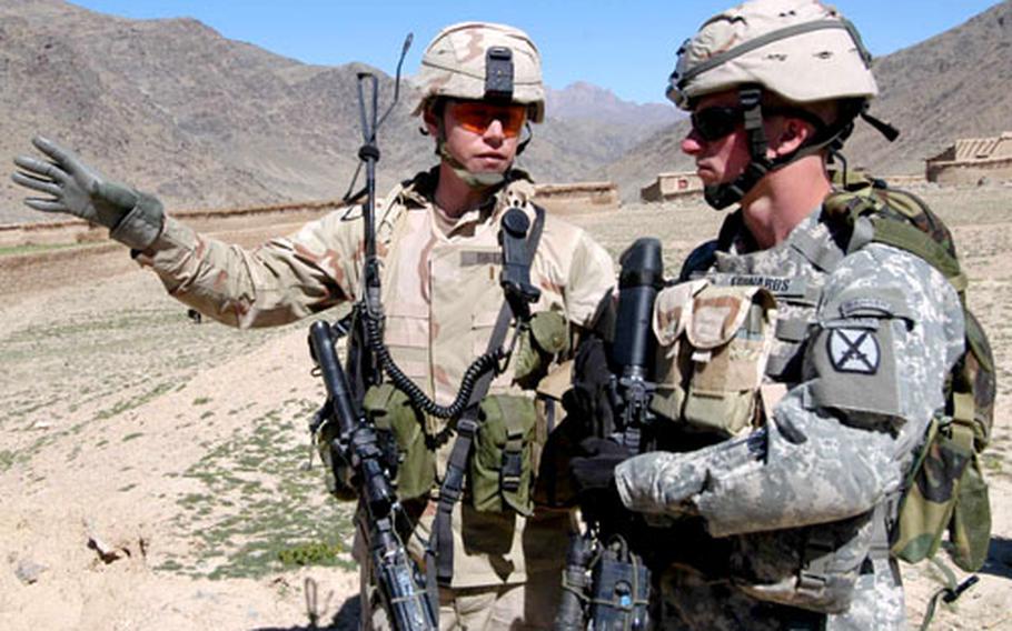 Second Lt. Ian Dietz, left, of 3rd Platoon, Company B, 2nd Battalion, 503rd Infantry Regiment, 173rd Airborne Brigade, talks with 1st Lt. Ryan Edwards, 1st Platoon, Company A, 2nd Brigade, 4th Infantry Regiment, 4th Brigade, 10th Mountain Division on an orientation tour of the villages near Forward Operating Base Arghandab in Afghanistan.