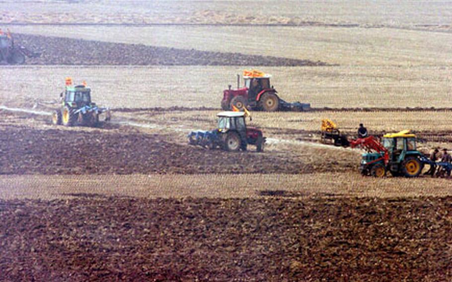 In the rice fields near Camp Humphreys in South Korea on Friday, protesting farmers defy a South Korean no-farming order and plow up a tract of rice country.