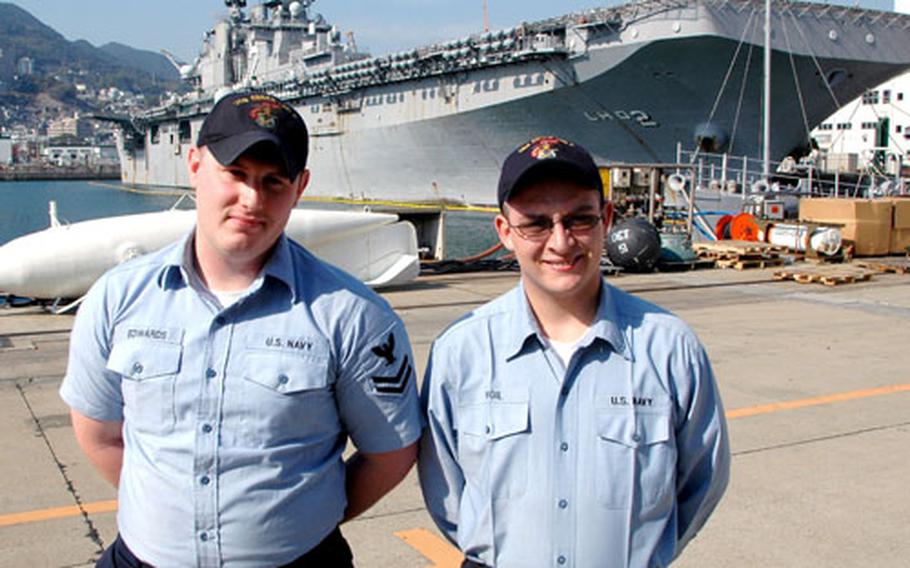 Petty Officer 2nd Class Timothy Edwards, left, and Petty Officer 3rd Class Timothy Vigil, USS Essex shipmates, stand at the India Basin pier at Sasebo Naval Base on Friday. The two helped several Japanese neighbors to safety and tried to rescue two others who died in a house fire in their off-base neighborhood Thursday night.