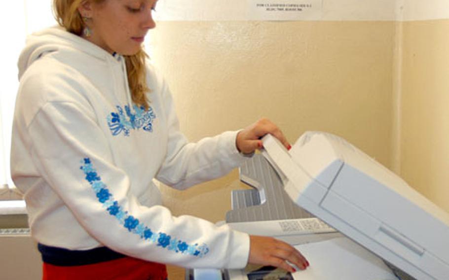 Ashlee Kozel, 15, makes copies as part of her job as a Morale, Welfare and Recreation marketing assistant through the Summer Hire program in Bamberg, Germany, in 2005.