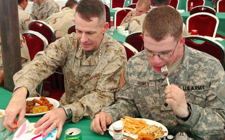 During a stop at Muzaffarabad, Pakistan, Chairman of the Joint Chiefs of Staff Gen. Peter Pace, left, had lunch with soldiers from the 10th Mountain Division of Fort Drum, N.Y.