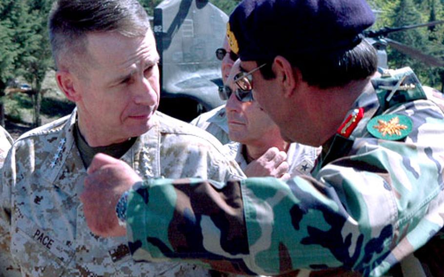 Gen. Peter Pace, Chairman of the Joint Chiefs of Staff, talks with Pakistani Army 12th Heavy Mountain Division commander Brig. Gen. Khalid Nawaz during a visit to Muzaffarabad, Pakistan on Tuesday.
