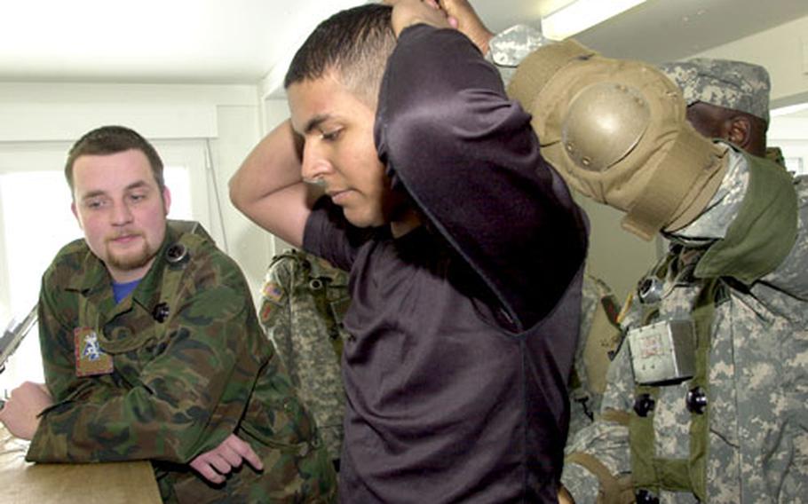 German university student Alexander Grellmann, left, role plays as a translator while 1st Battalion, 4th Infantry Regiment soldier Sgt. Arturo Brito, 29, of Bronx, N.Y. role plays as an insurgent at Hohenfels last Monday. Brito met his wife, Elena Friedmann, at the training range. The couple is to be featured in a German television documentary later this year.